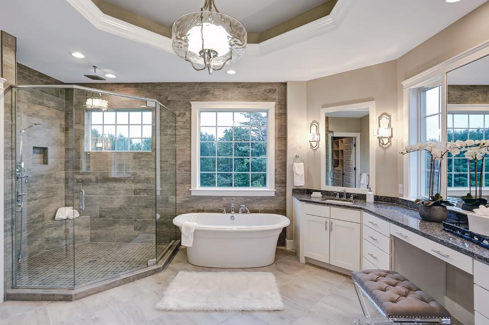 Design ideas for a medium sized country ensuite bathroom in Other with white cabinets, a freestanding bath, a corner shower, a two-piece toilet, ceramic tiles, beige walls, ceramic flooring, an integrated sink, granite worktops and a hinged door.