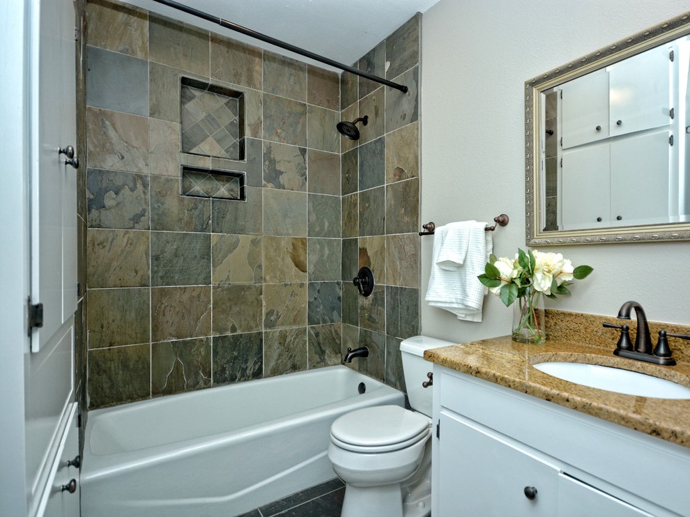 Immagine di una piccola stanza da bagno padronale stile americano con ante lisce, ante bianche, vasca da incasso, vasca/doccia, piastrelle beige, piastrelle in pietra, lavabo da incasso e top in pietra calcarea