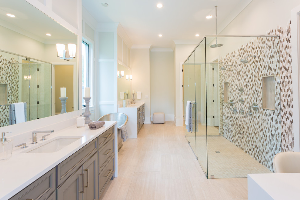 Пример оригинального дизайна: главная ванная комната в стиле неоклассика (современная классика) с фасадами с утопленной филенкой, серыми фасадами, отдельно стоящей ванной, двойным душем, разноцветной плиткой, плиткой мозаикой, серыми стенами, врезной раковиной, бежевым полом, душем с распашными дверями, белой столешницей и зеркалом с подсветкой