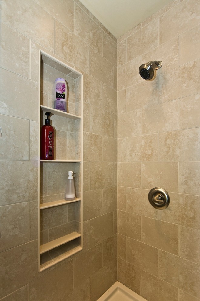 Corner shower - small modern master beige tile and ceramic tile ceramic tile corner shower idea in Philadelphia with furniture-like cabinets, medium tone wood cabinets, a two-piece toilet, beige walls, an undermount sink and granite countertops