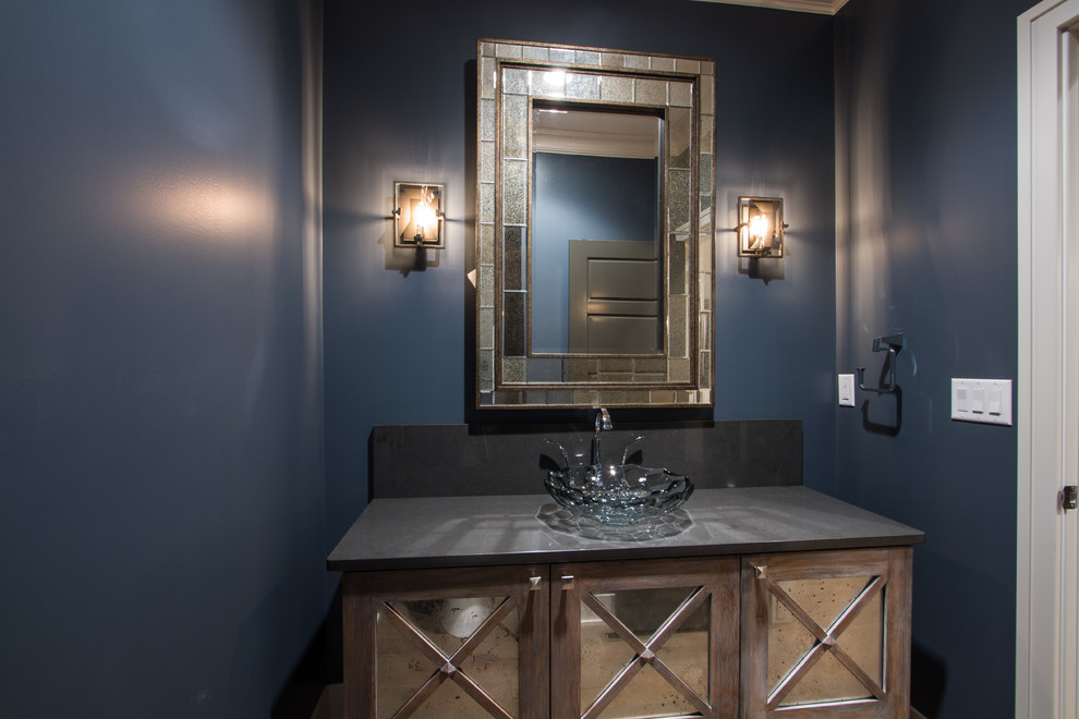 Mid-sized elegant 3/4 light wood floor bathroom photo in Omaha with distressed cabinets, glass-front cabinets, blue walls, a vessel sink and solid surface countertops