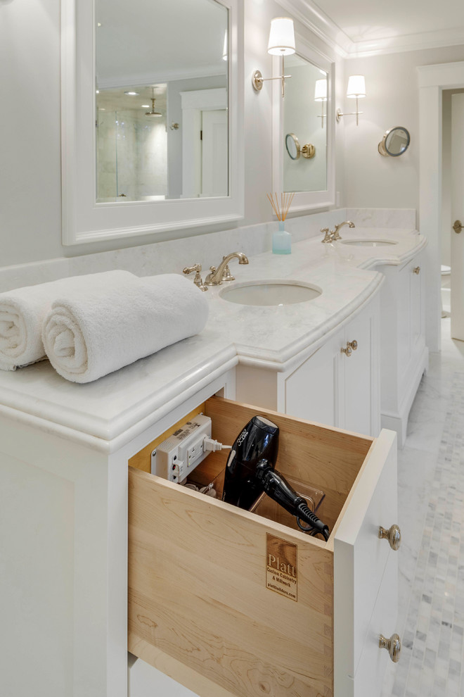 This is an example of a large traditional ensuite bathroom in Boston with white cabinets, a freestanding bath, a walk-in shower, beige tiles, ceramic tiles, grey walls, marble flooring, a submerged sink, marble worktops, white floors, a hinged door and white worktops.