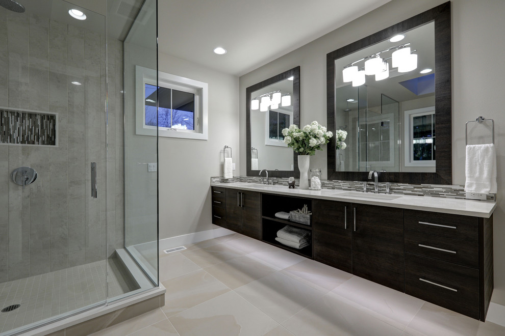 Inspiration for a mid-sized modern master gray tile ceramic tile freestanding bathtub remodel in Los Angeles with gray walls, quartzite countertops and a hinged shower door
