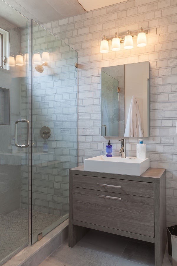 Inspiration for an expansive contemporary bathroom in Los Angeles with flat-panel cabinets, grey cabinets, white tiles, mosaic tiles, grey walls and porcelain flooring.