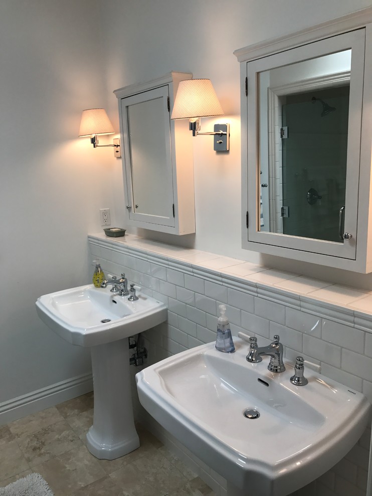 Mid-sized elegant 3/4 gray tile and subway tile travertine floor and beige floor bathroom photo in Orange County with gray walls, a pedestal sink and solid surface countertops