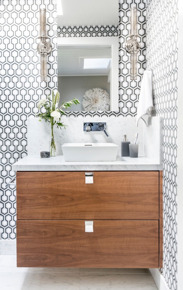 This is an example of a medium sized contemporary shower room bathroom in San Francisco with flat-panel cabinets, multi-coloured walls, a vessel sink, marble worktops, white floors, medium wood cabinets and ceramic flooring.