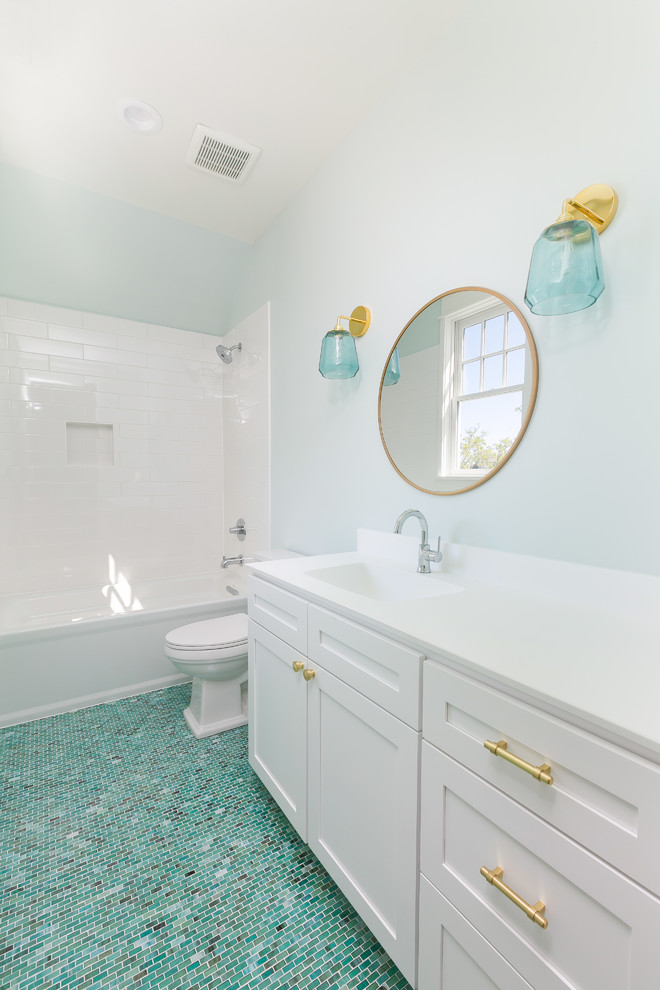 Inspiration for a medium sized rural bathroom in Charleston with green walls, recessed-panel cabinets, white cabinets, an alcove bath, a shower/bath combination, white tiles, metro tiles, mosaic tile flooring, an integrated sink, engineered stone worktops, turquoise floors, a shower curtain and white worktops.