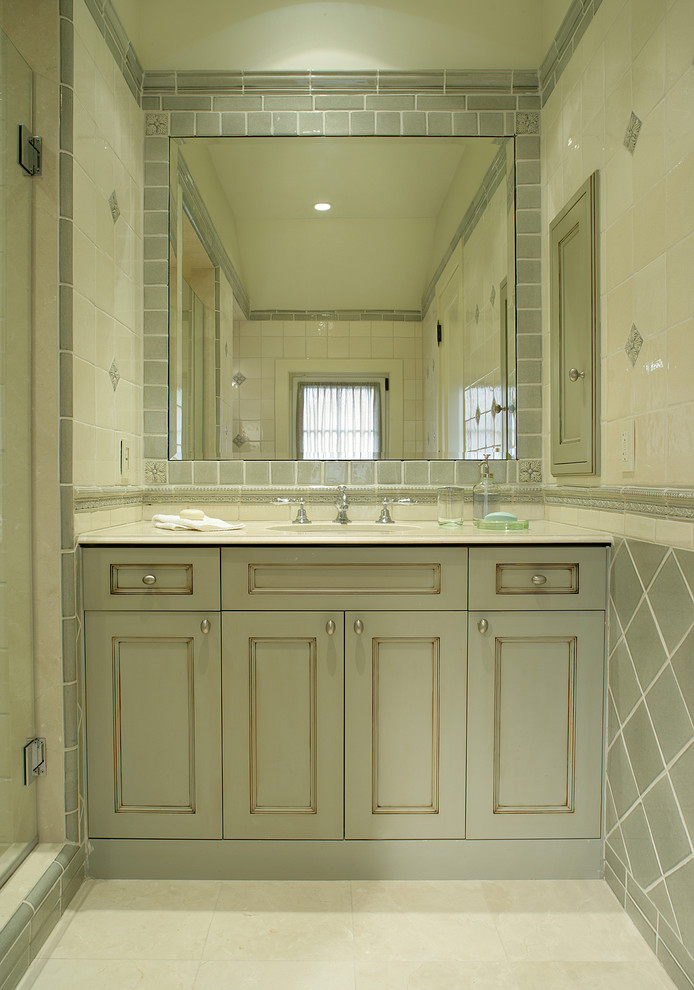 Classic bathroom in New York with green cabinets and ceramic tiles.