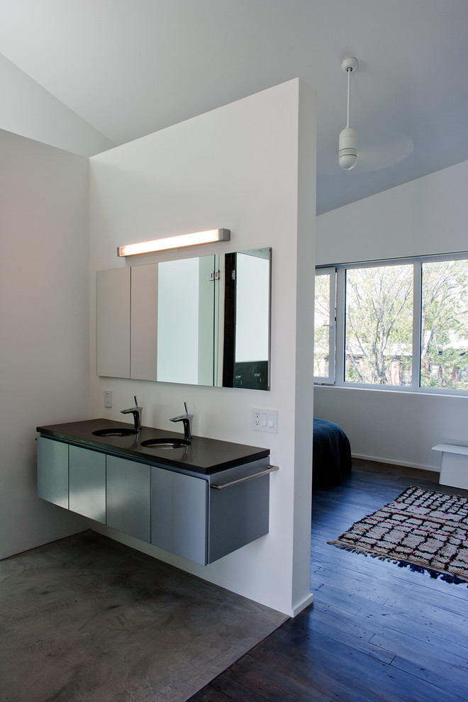 Photo of a large modern ensuite bathroom in New York with flat-panel cabinets, grey cabinets, a double shower, grey walls, concrete flooring, a submerged sink, engineered stone worktops, grey floors and a hinged door.