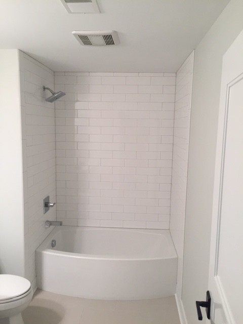 Bild på ett mellanstort funkis badrum för barn, med ett platsbyggt badkar, en öppen dusch, en toalettstol med hel cisternkåpa, vit kakel, tunnelbanekakel, grå väggar, klinkergolv i keramik, grått golv och dusch med duschdraperi