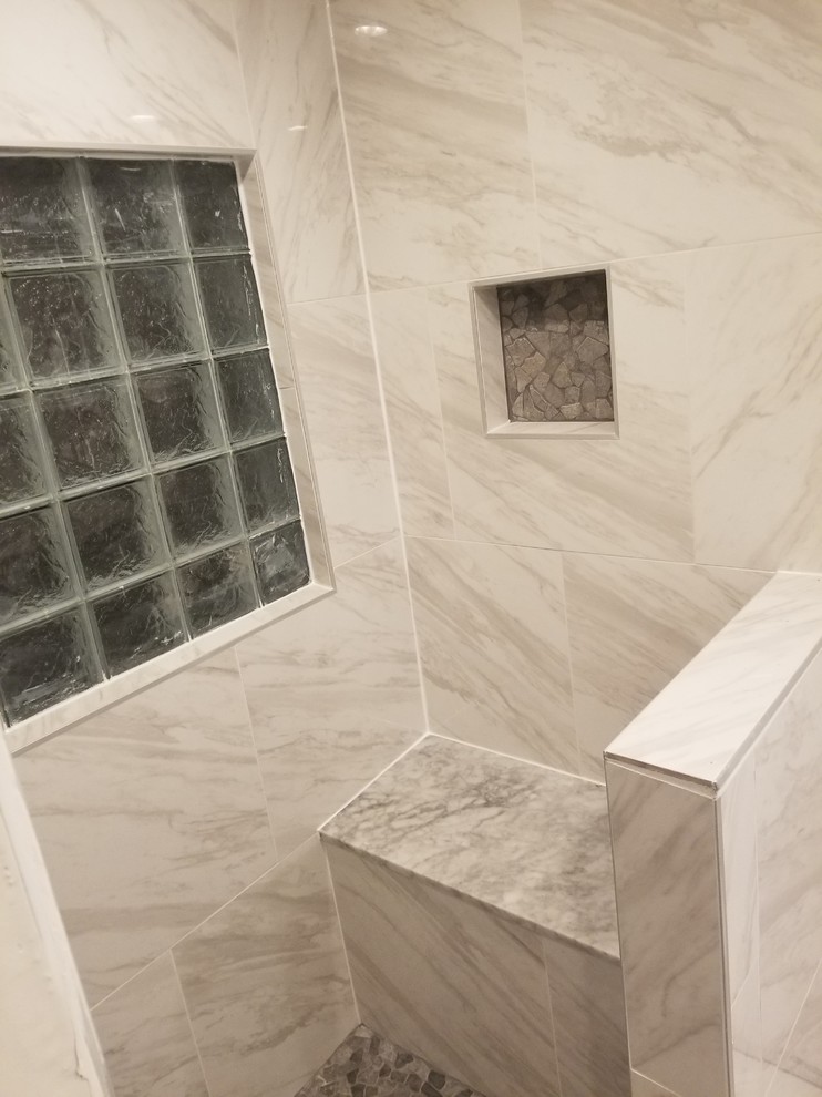 Diseño de cuarto de baño de estilo americano de tamaño medio con ducha empotrada, baldosas y/o azulejos grises, baldosas y/o azulejos de porcelana, paredes grises, suelo de baldosas tipo guijarro, aseo y ducha, suelo gris y ducha abierta