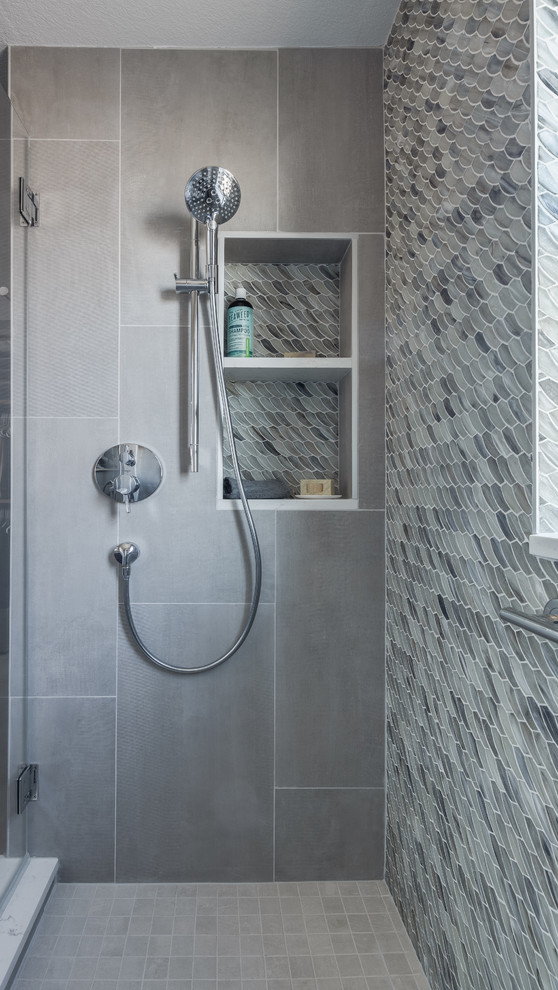 This is an example of a small classic grey and white ensuite bathroom in Other with flat-panel cabinets, dark wood cabinets, a double shower, a two-piece toilet, multi-coloured tiles, glass tiles, grey walls, cement flooring, a submerged sink, engineered stone worktops, grey floors, a hinged door, white worktops, feature lighting, a wall niche, double sinks and a floating vanity unit.