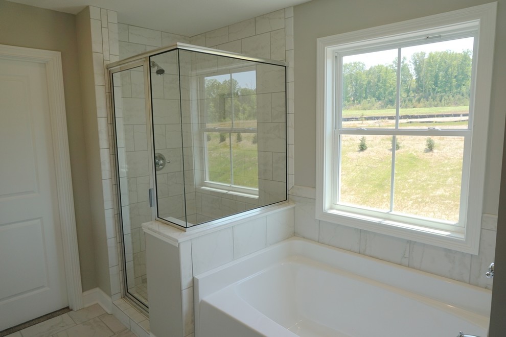 Example of a large trendy master white tile and porcelain tile marble floor and gray floor bathroom design in Other with recessed-panel cabinets, white cabinets, gray walls, an undermount sink and a hinged shower door