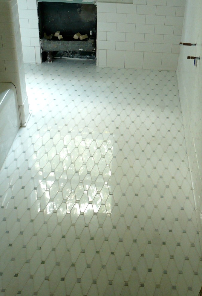 Cette photo montre une salle de bain chic avec une douche d'angle, un carrelage beige, un carrelage métro et un plan de toilette en granite.