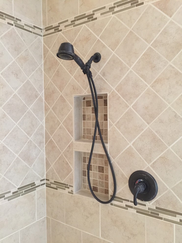 Mid-sized arts and crafts master beige tile and porcelain tile porcelain tile doorless shower photo in Other with an undermount sink, dark wood cabinets, quartz countertops, a two-piece toilet and orange walls