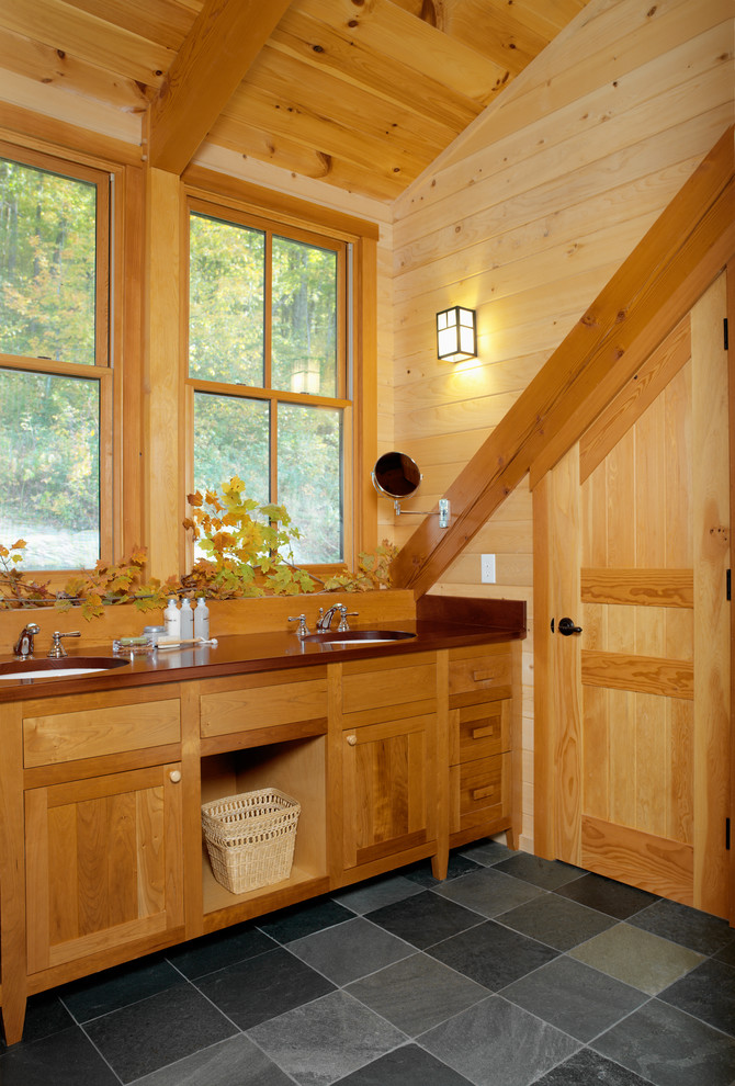 This is an example of a rustic bathroom in Burlington with shaker cabinets, medium wood cabinets, a submerged sink and grey floors.