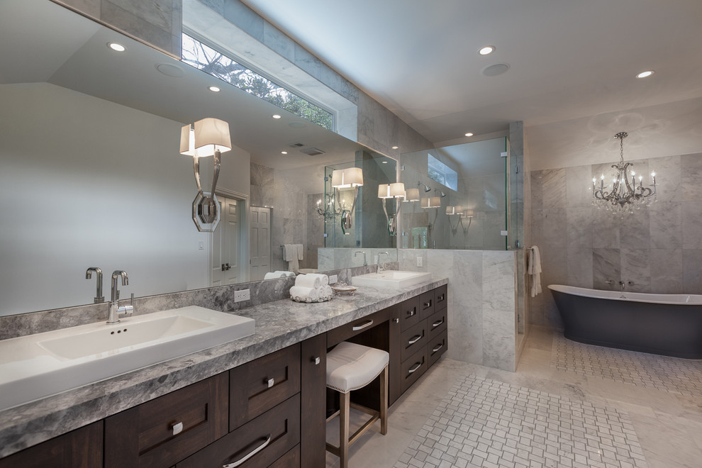Example of a large classic gray tile and stone tile marble floor bathroom design in Houston with a drop-in sink, furniture-like cabinets, dark wood cabinets, marble countertops and gray walls