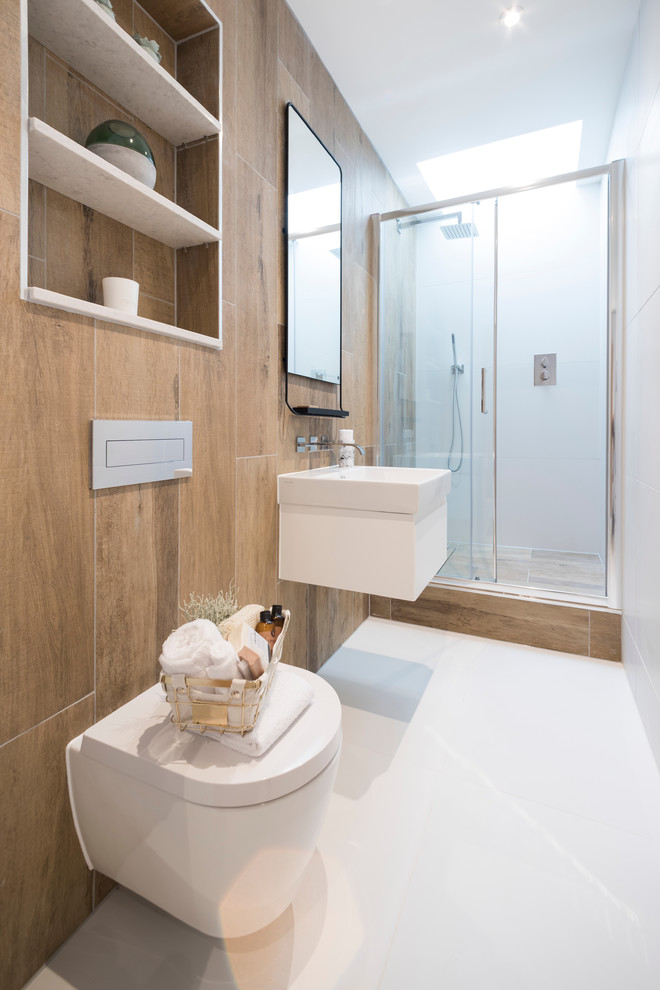 Inspiration for a medium sized contemporary bathroom in Dorset with a wall mounted toilet, white walls and a wall-mounted sink.