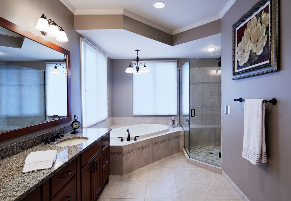 Medium sized traditional ensuite bathroom in Detroit with a submerged sink, recessed-panel cabinets, dark wood cabinets, granite worktops, a corner shower, beige tiles, ceramic tiles, grey walls, porcelain flooring and a built-in bath.