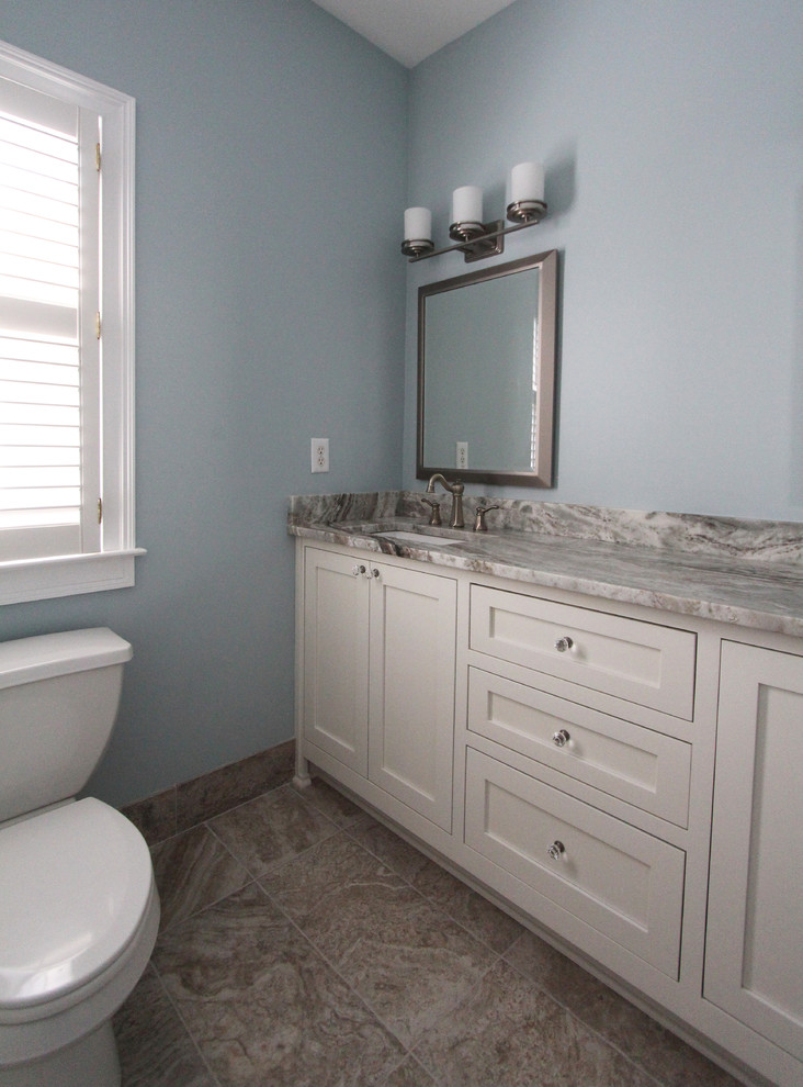 Inspiration for a medium sized traditional family bathroom in Atlanta with a submerged sink, flat-panel cabinets, white cabinets, quartz worktops, an alcove bath, a shower/bath combination, a two-piece toilet, brown tiles, ceramic tiles, blue walls and ceramic flooring.