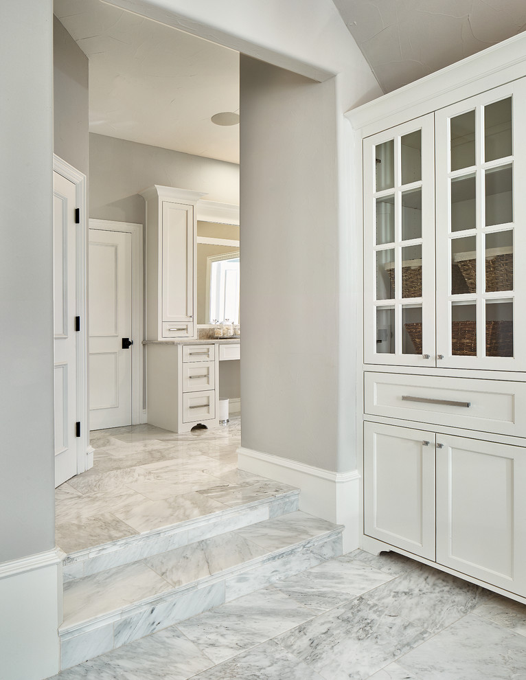Design ideas for a traditional bathroom in Dallas with recessed-panel cabinets, white cabinets, a submerged bath, an alcove shower, white tiles, marble tiles, grey walls, marble flooring, a submerged sink, marble worktops, white floors and a hinged door.