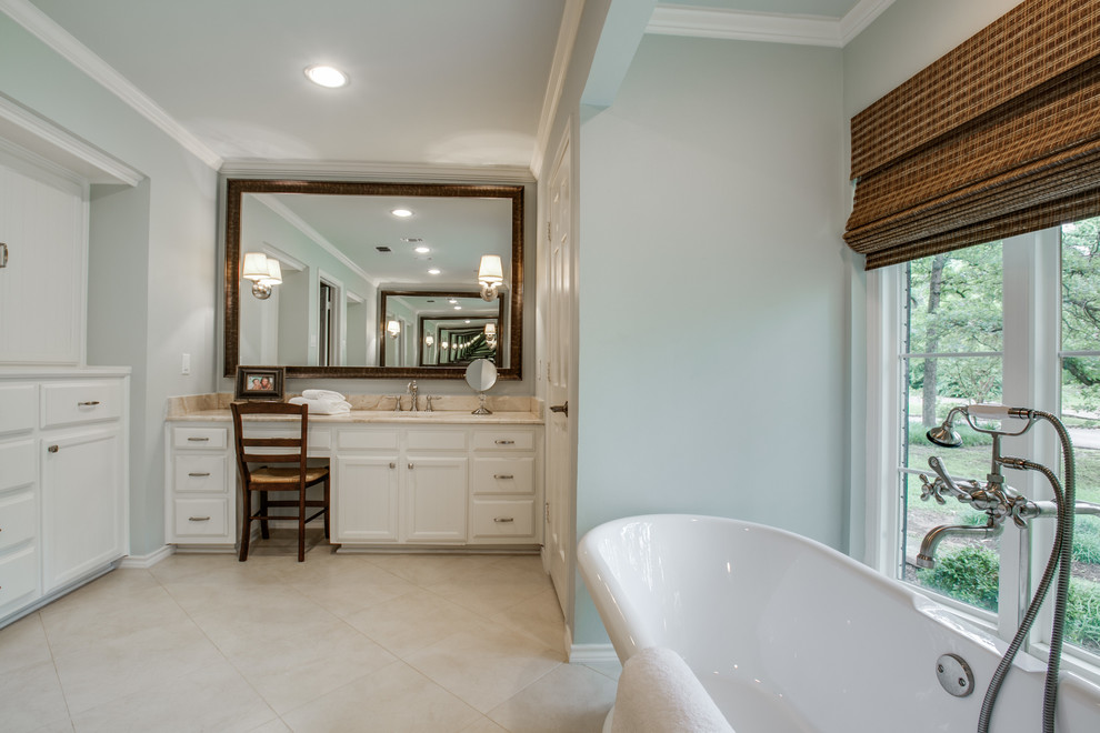 Photo of a large traditional ensuite bathroom in Dallas with recessed-panel cabinets, white cabinets, a freestanding bath, a corner shower, grey walls, porcelain flooring, a submerged sink, marble worktops, beige floors and a hinged door.