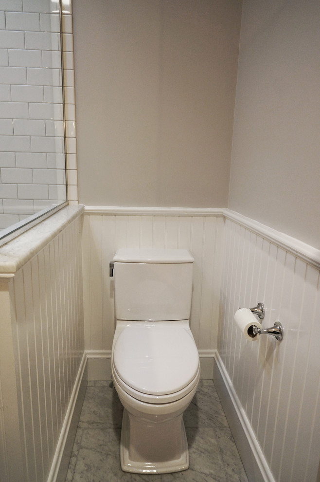 Design ideas for a medium sized traditional cloakroom in Boston with shaker cabinets, dark wood cabinets, a two-piece toilet, white tiles, ceramic tiles, grey walls, marble flooring, a submerged sink and marble worktops.