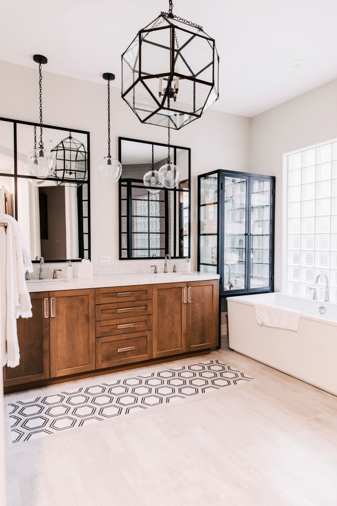 Classic bathroom in Phoenix with shaker cabinets, medium wood cabinets, a freestanding bath, grey walls, a submerged sink, beige floors, white worktops, double sinks and a built in vanity unit.