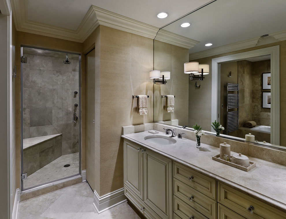 This is an example of a medium sized contemporary ensuite bathroom in Chicago with raised-panel cabinets, beige cabinets, a built-in bath, an alcove shower, grey tiles, marble tiles, beige walls, marble flooring, a submerged sink, marble worktops, white floors and a hinged door.