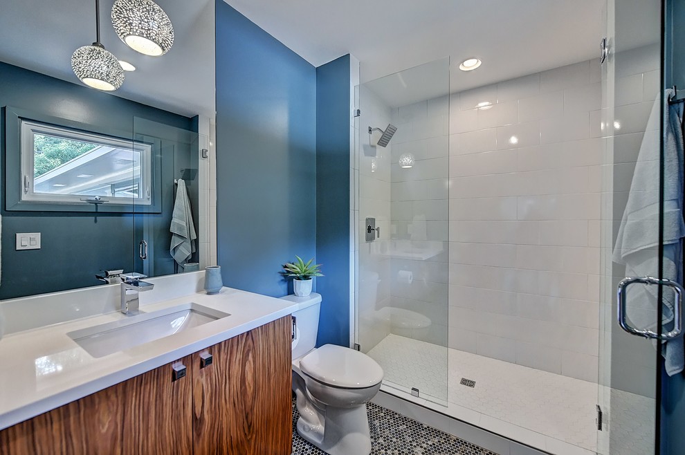 Example of a small 1960s ceramic tile mosaic tile floor and multicolored floor doorless shower design in Charlotte with dark wood cabinets, a two-piece toilet, an undermount sink, quartz countertops and a hinged shower door