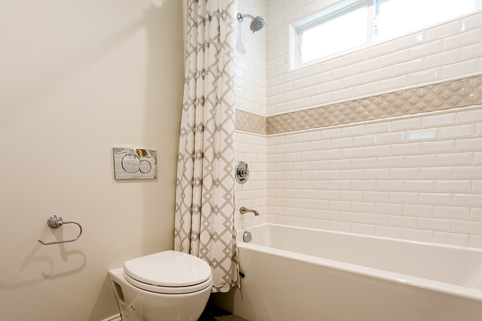 Aménagement d'une salle d'eau classique avec une baignoire en alcôve, un combiné douche/baignoire, un mur beige et une cabine de douche avec un rideau.