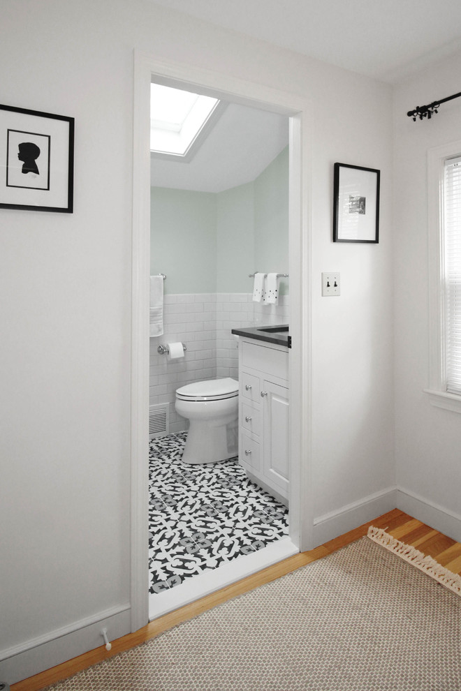 This is an example of a small classic ensuite bathroom in Boston with shaker cabinets, white cabinets, an alcove bath, a shower/bath combination, a two-piece toilet, white tiles, ceramic tiles, green walls, ceramic flooring, a submerged sink, engineered stone worktops, multi-coloured floors, a shower curtain and grey worktops.