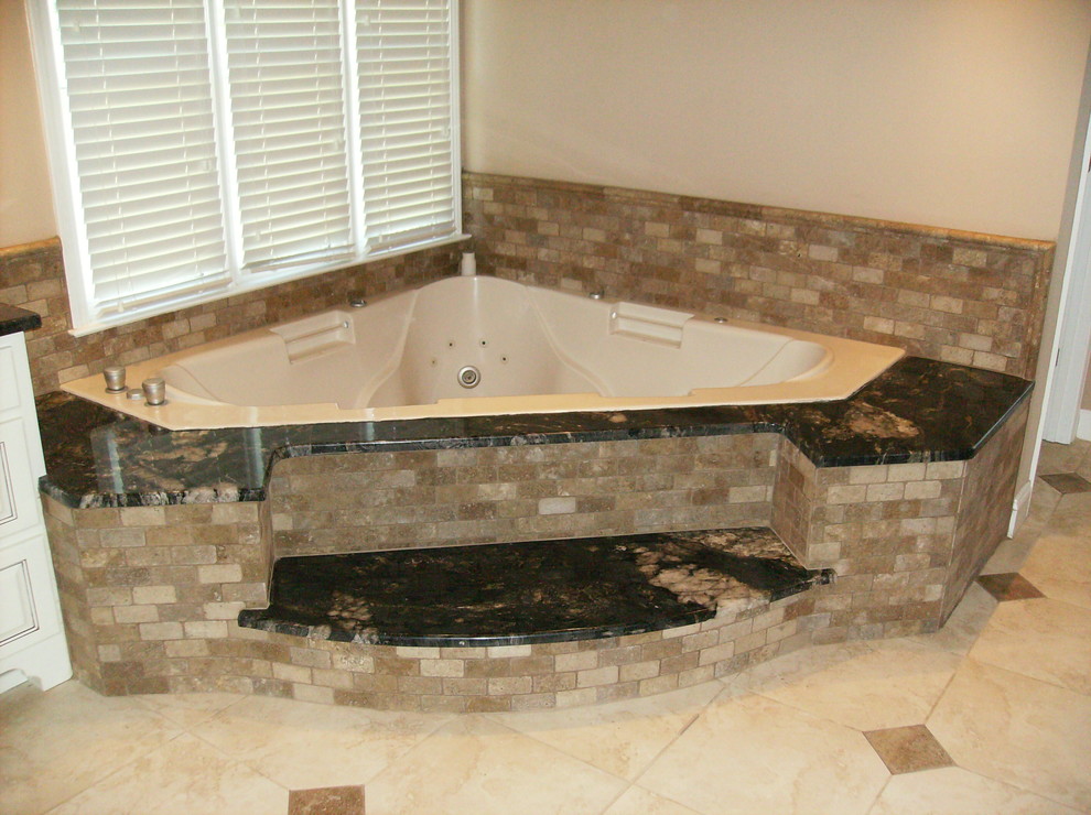Mid-sized transitional master beige tile, black tile and stone tile travertine floor and beige floor bathroom photo in Atlanta with a hot tub, white walls and granite countertops