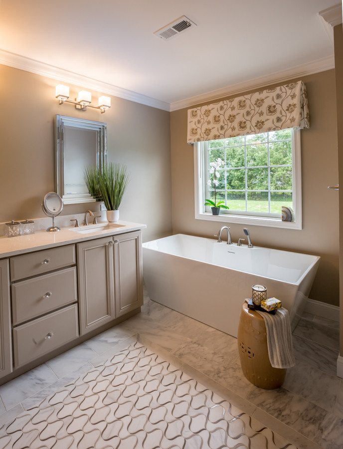 Inspiration for a large traditional ensuite bathroom in New York with recessed-panel cabinets, a freestanding bath, an alcove shower, a one-piece toilet, marble flooring, a submerged sink and engineered stone worktops.
