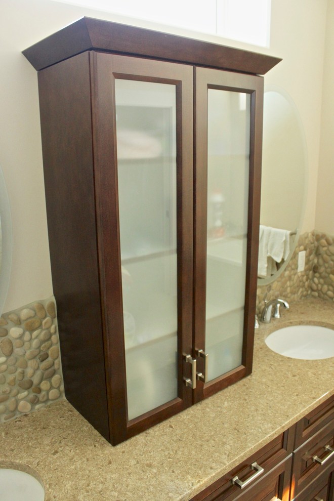 Example of a large arts and crafts master beige tile and pebble tile ceramic tile bathroom design in Vancouver with raised-panel cabinets, dark wood cabinets, a two-piece toilet, beige walls, an undermount sink and quartz countertops
