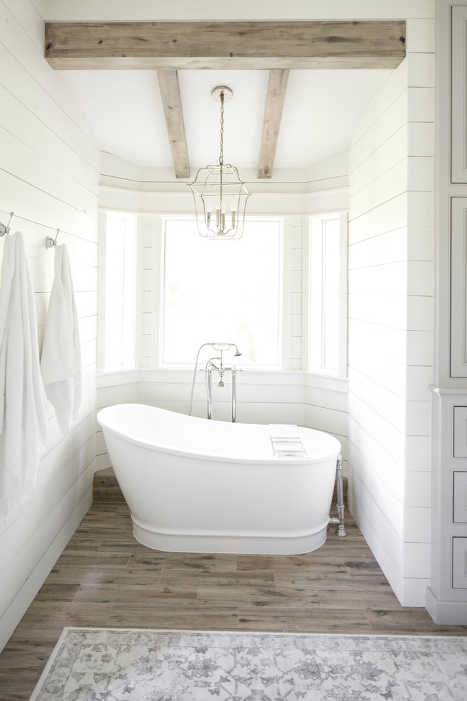 Inspiration for a large farmhouse master freestanding bathtub remodel in Houston