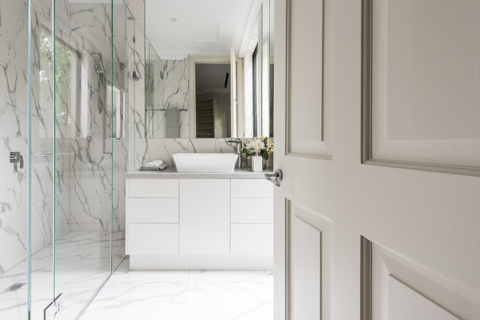 Inredning av ett modernt stort en-suite badrum, med släta luckor, vita skåp, en kantlös dusch, svart och vit kakel, porslinskakel, klinkergolv i porslin, ett fristående handfat, bänkskiva i kvarts, vitt golv och dusch med gångjärnsdörr