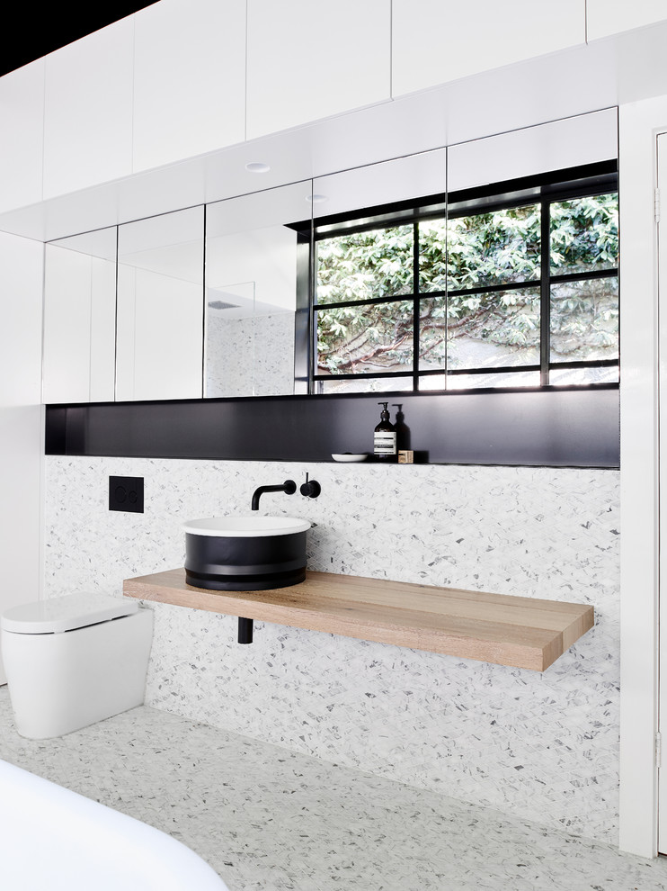 Contemporary bathroom in Melbourne with a freestanding bath, mosaic tiles and mosaic tile flooring.