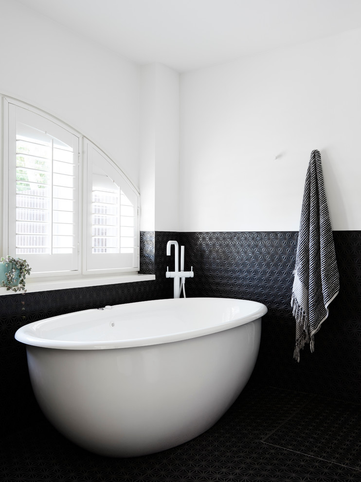Design ideas for a contemporary half tiled bathroom in Melbourne with mosaic tile flooring, a pedestal sink and a freestanding bath.