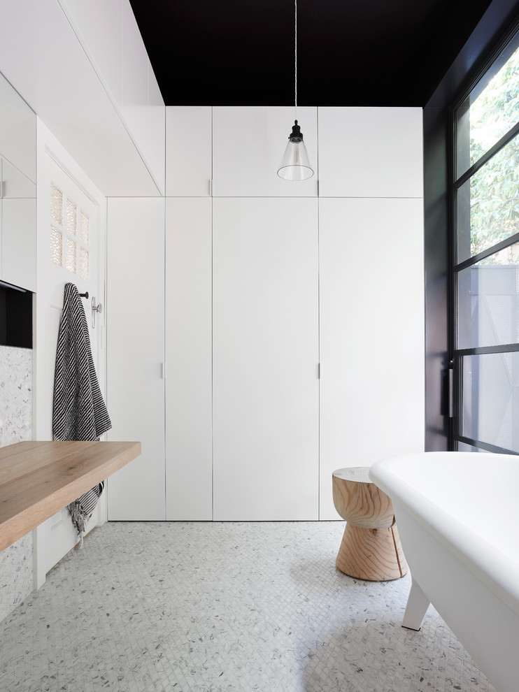 Contemporary bathroom in Melbourne with a freestanding bath and mosaic tile flooring.
