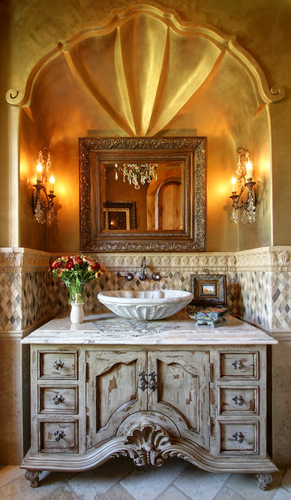 Huge mountain style master multicolored tile and mosaic tile travertine floor and beige floor bathroom photo in Phoenix with furniture-like cabinets, distressed cabinets, a one-piece toilet, multicolored walls, a vessel sink, quartzite countertops, a hinged shower door and multicolored countertops