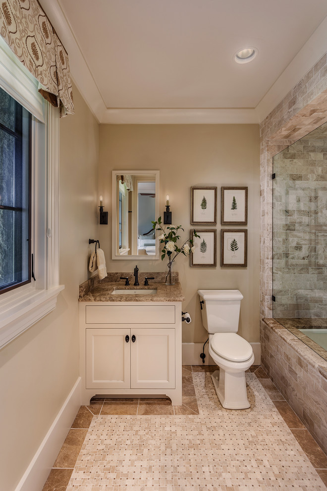 Bathroom - mid-sized mediterranean beige tile ceramic tile and multicolored floor bathroom idea in Other with beige walls, a vessel sink, granite countertops, a one-piece toilet, a hinged shower door, shaker cabinets and white cabinets