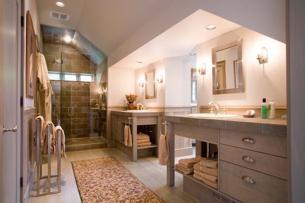 This is an example of a medium sized traditional ensuite bathroom in Other with freestanding cabinets, light wood cabinets, an alcove shower, beige walls, light hardwood flooring, a built-in sink, brown floors and a hinged door.