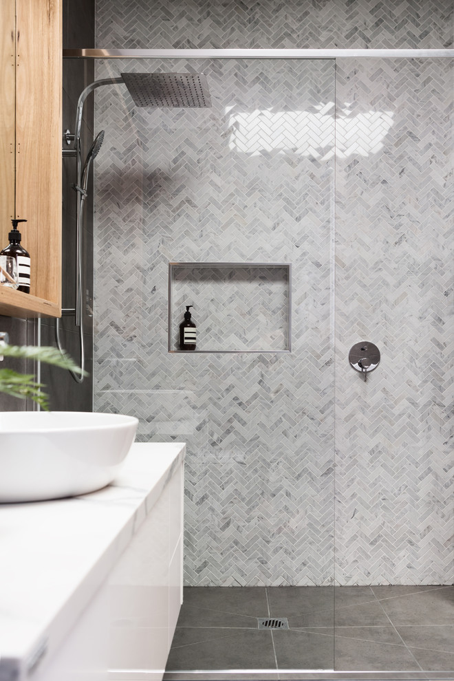 Photo of a medium sized modern ensuite bathroom in Los Angeles with white cabinets, grey tiles, mosaic tiles, grey walls, ceramic flooring, a vessel sink, marble worktops, grey floors and a hinged door.