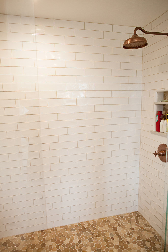 Alcove shower - mid-sized coastal 3/4 beige tile, gray tile, multicolored tile and mosaic tile dark wood floor alcove shower idea in San Francisco with recessed-panel cabinets, white cabinets, a two-piece toilet, white walls, a drop-in sink and quartz countertops