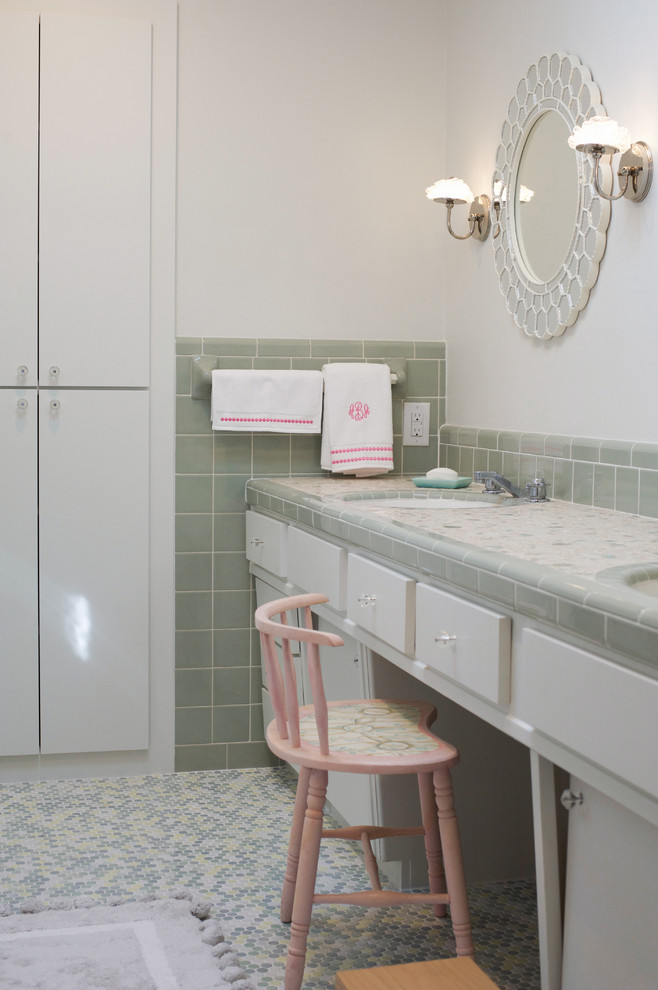 This is an example of a classic family bathroom in Dallas with white cabinets, multi-coloured tiles, white walls, a submerged sink and tiled worktops.