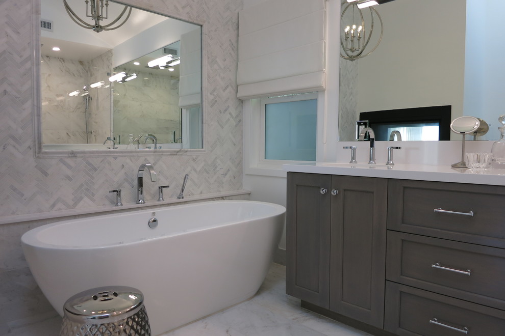 Inspiration for a medium sized contemporary ensuite bathroom in Los Angeles with recessed-panel cabinets, medium wood cabinets, a freestanding bath, an alcove shower, white tiles, marble tiles, white walls, marble flooring, a submerged sink, engineered stone worktops, white floors, a hinged door and white worktops.