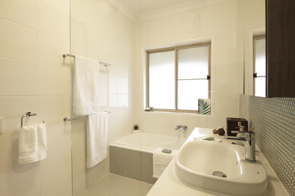 Inspiration for a small contemporary family bathroom in Brisbane with flat-panel cabinets, green cabinets, a built-in bath, a built-in shower, a two-piece toilet, white tiles, mosaic tiles, white walls, porcelain flooring, a vessel sink, engineered stone worktops, beige floors, a hinged door and white worktops.