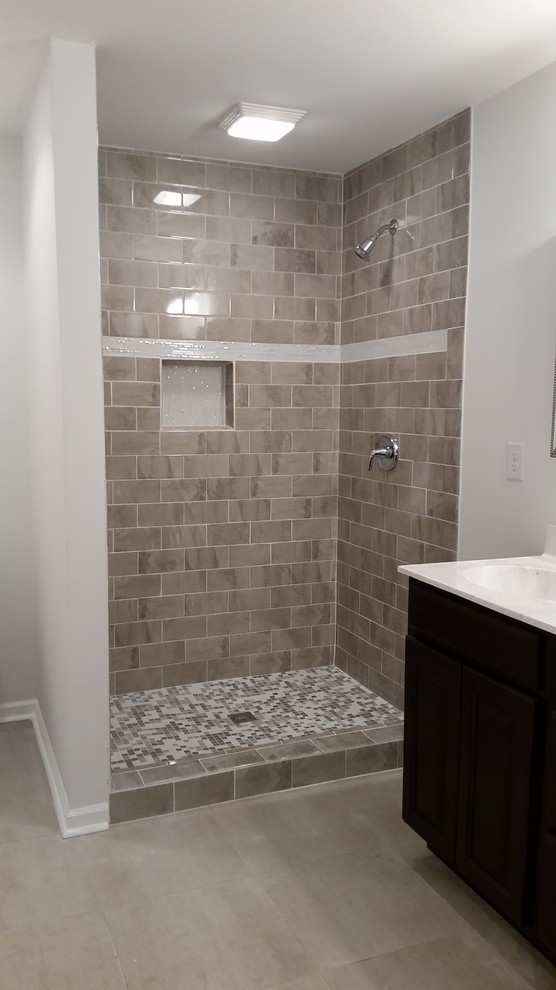 Design ideas for a medium sized classic ensuite bathroom in Nashville with shaker cabinets, dark wood cabinets, an alcove shower, beige tiles, white walls, porcelain flooring, porcelain tiles, an integrated sink, marble worktops, beige floors, a shower curtain and white worktops.