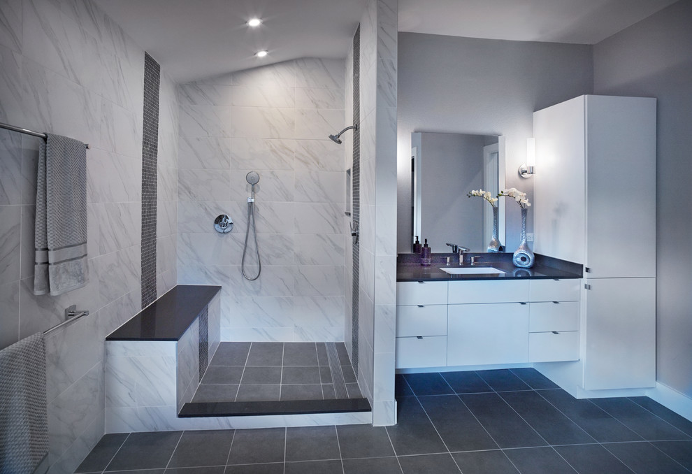 Inspiration for a large contemporary ensuite bathroom in Dallas with flat-panel cabinets, white cabinets, a freestanding bath, a walk-in shower, grey tiles, porcelain tiles, grey walls, porcelain flooring, a submerged sink and engineered stone worktops.